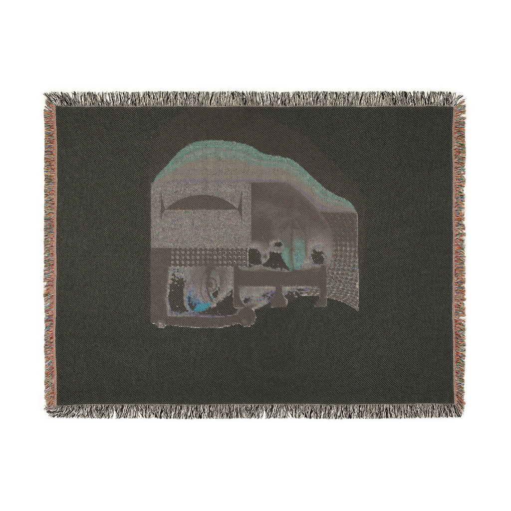 PURETE woven cotton throw blanket featuring a dark abstract portrait design with fringed edges on a white background