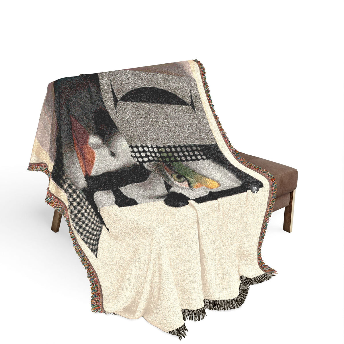 PURETE woven cotton throw blanket featuring a bold abstract portrait design with fringed edges draped over a chair