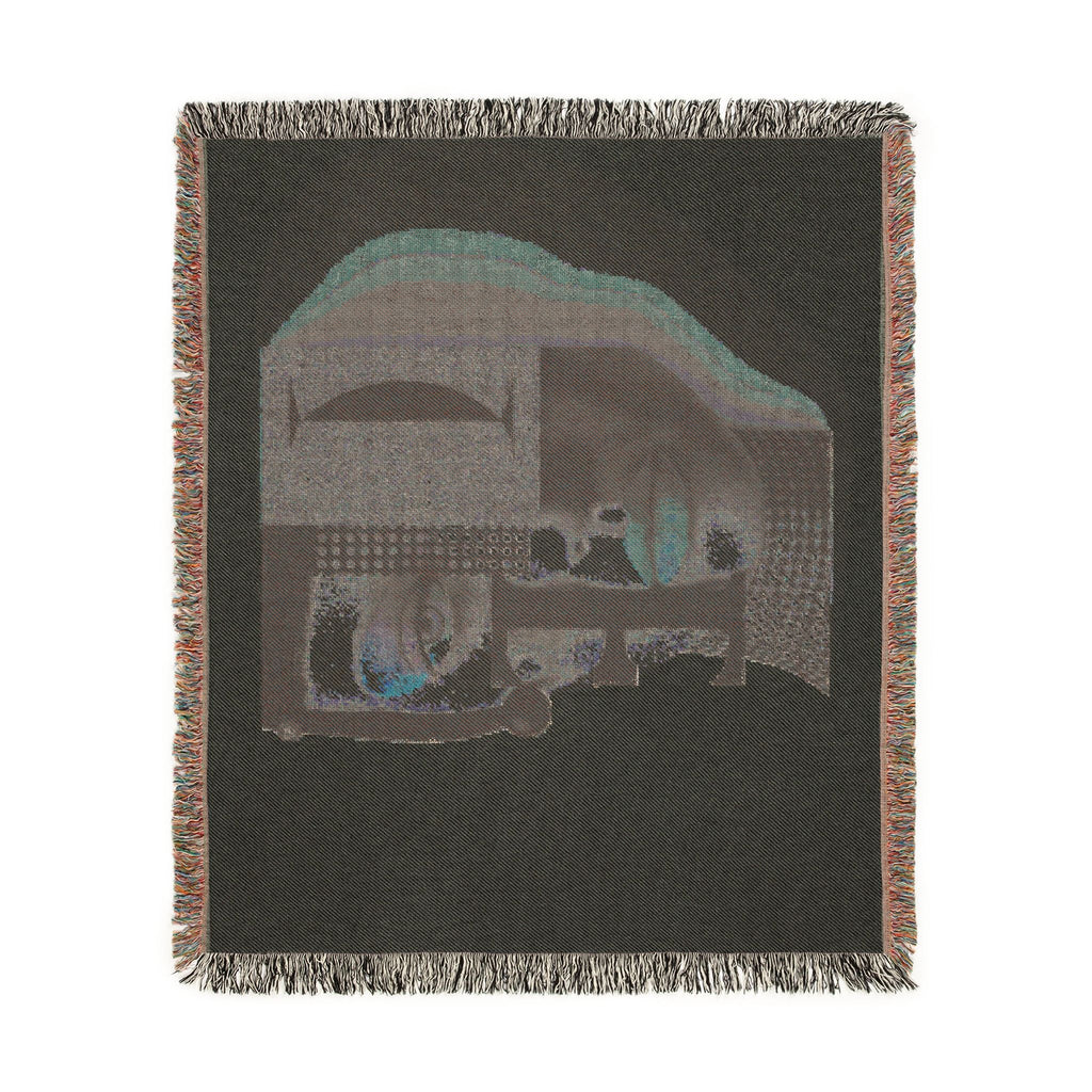 PURETE woven cotton throw blanket featuring a dark abstract portrait design with geometric shapes and fringed edges.
