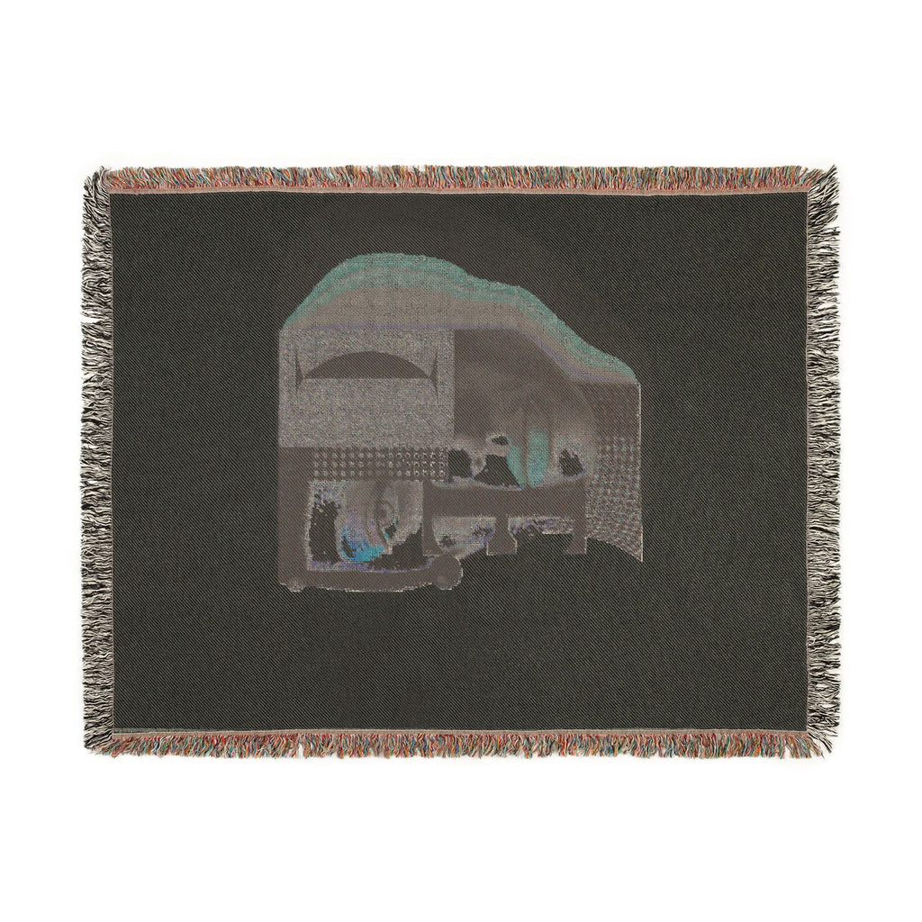 PURETE woven cotton throw blanket featuring a dark abstract portrait design with geometric shapes and fringed edges
