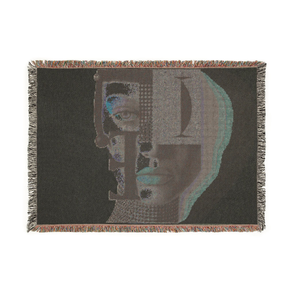 PURETE woven cotton throw blanket featuring a dark abstract portrait design with geometric shapes and fringed edges.