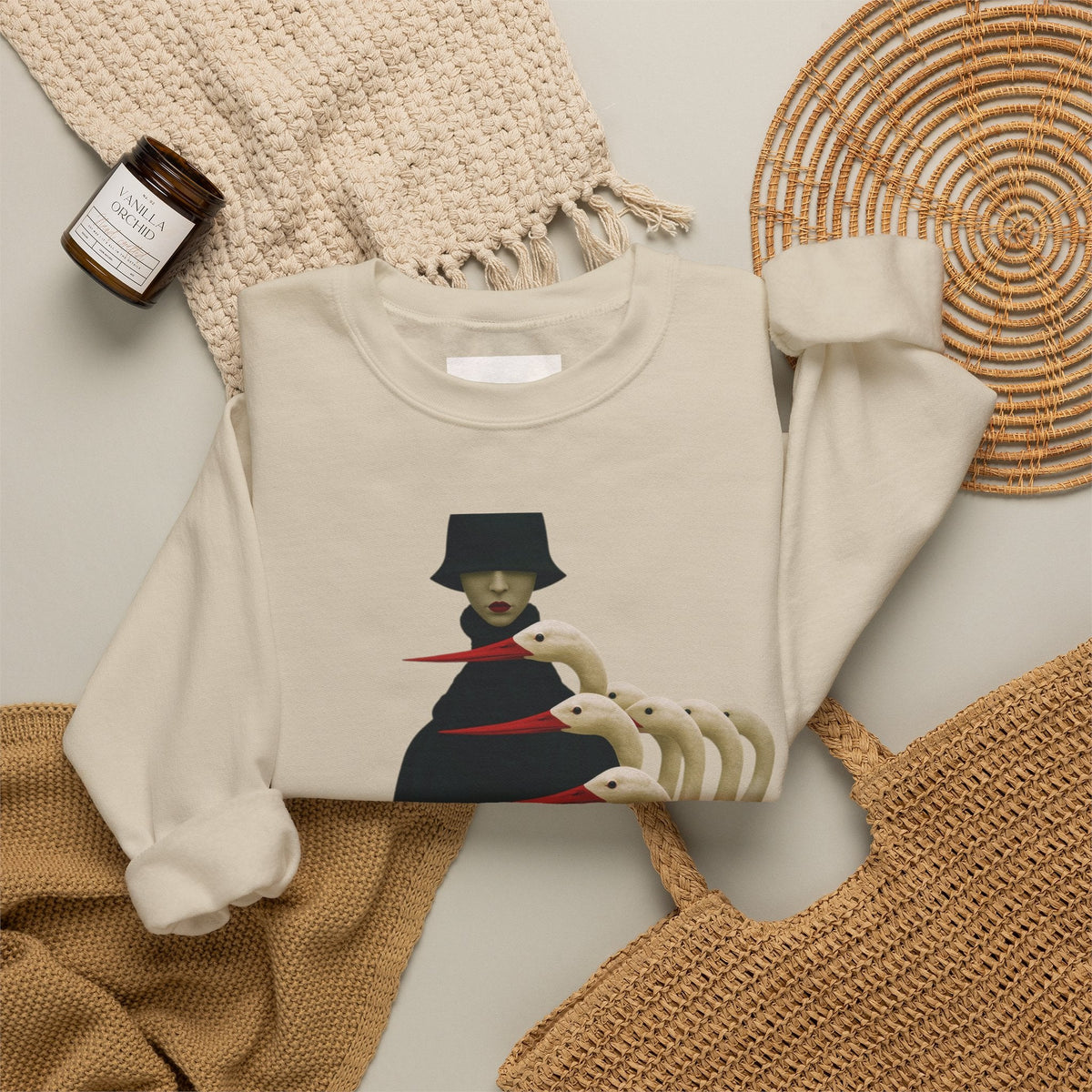PURETE beige crewneck sweatshirt featuring a surreal graphic of a cloaked figure with white birds on a neutral background