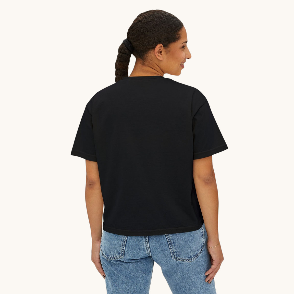 A woman wearing a black PURETE boxy oversized cotton t-shirt, viewed from the back against a plain white background.