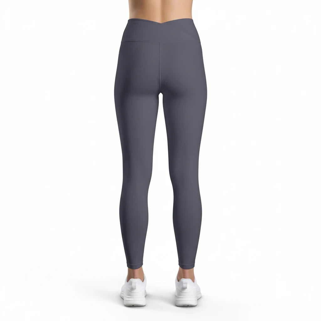Back view of PURETE high-waist charcoal grey yoga leggings with a contoured V-cut waistband on a model.