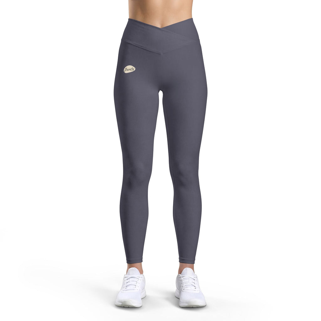 PURETE high-waist charcoal grey yoga leggings with a v-cut waistband and subtle logo, worn by a model in white sneakers.