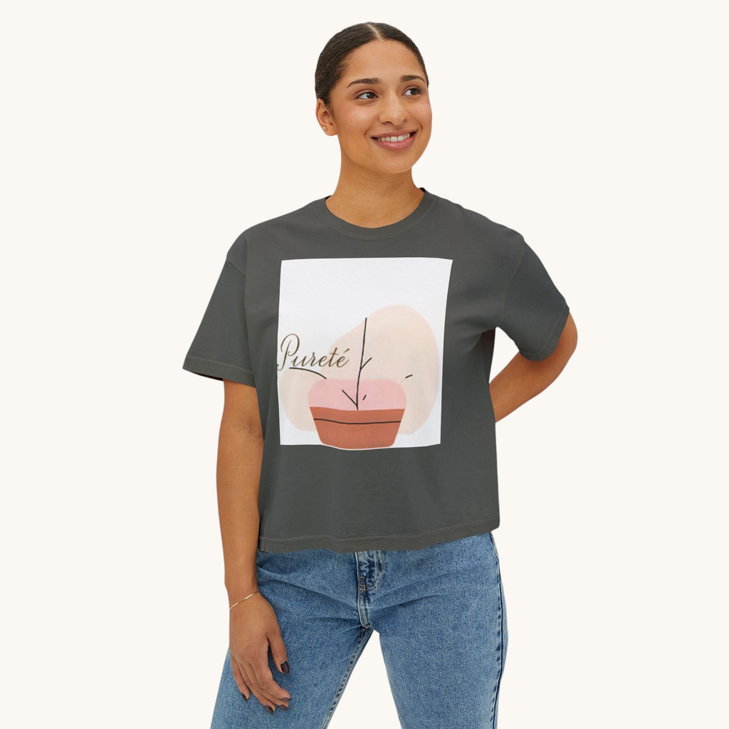 A woman wearing a PURETE charcoal grey boxy oversized cotton t-shirt with a minimalist abstract plant graphic print.