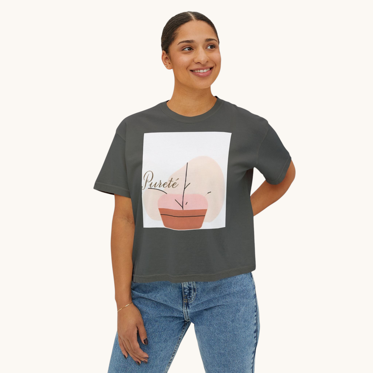 A woman wearing a PURETE charcoal grey boxy oversized cotton t-shirt with a minimalist abstract plant graphic print.