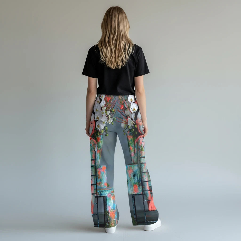 Woman wearing PURETE pajama pants with a vibrant floral and abstract print, featuring an elastic waistband.