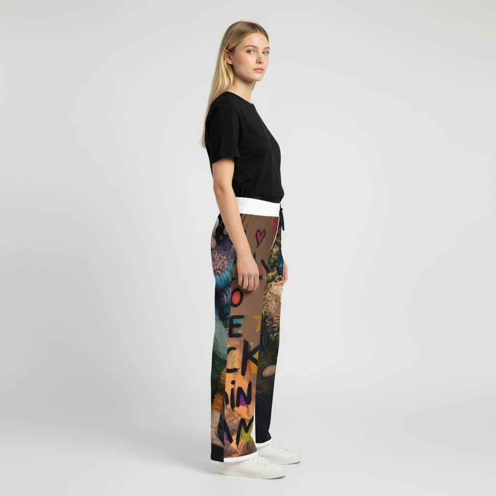 A woman wearing PURETE pajama pants with a colorful graphic print, elastic waistband, and a black t-shirt.