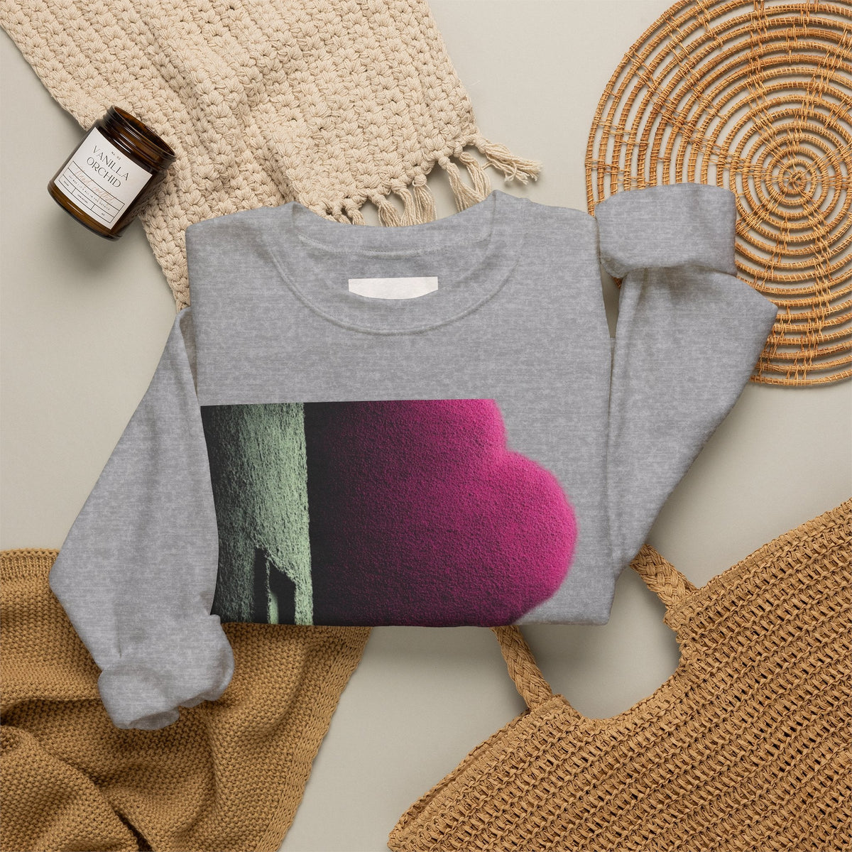 PURETE grey crewneck sweatshirt with a pink and green abstract graphic print, laid flat on a neutral textured background.