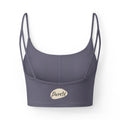 PURETE luxe crop sports bra in dark grey with slim double straps and a minimal plant pot graphic at the hem.