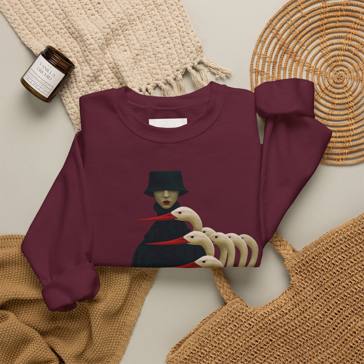 PURETE maroon crewneck sweatshirt featuring a surreal graphic of a cloaked figure with white bird heads