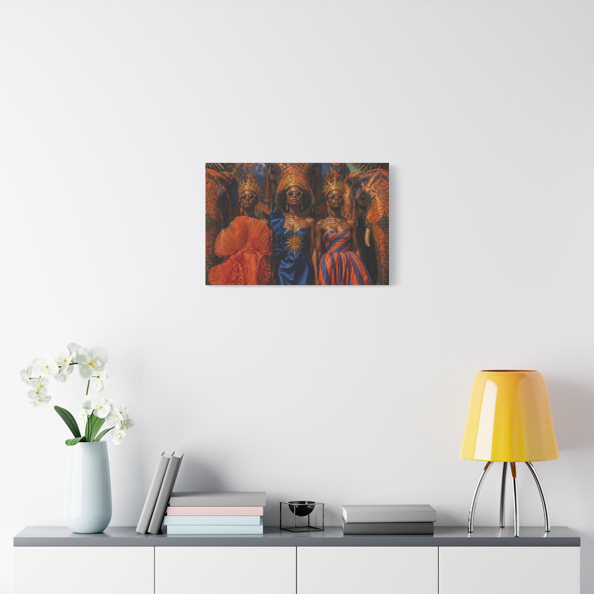 PURETE matte canvas print featuring three regal women in vibrant traditional attire displayed on a white wall