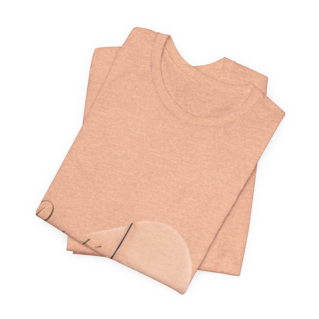 PURETE unisex jersey short sleeve tee in a soft peach heather cotton fabric, neatly folded with a crew neckline.