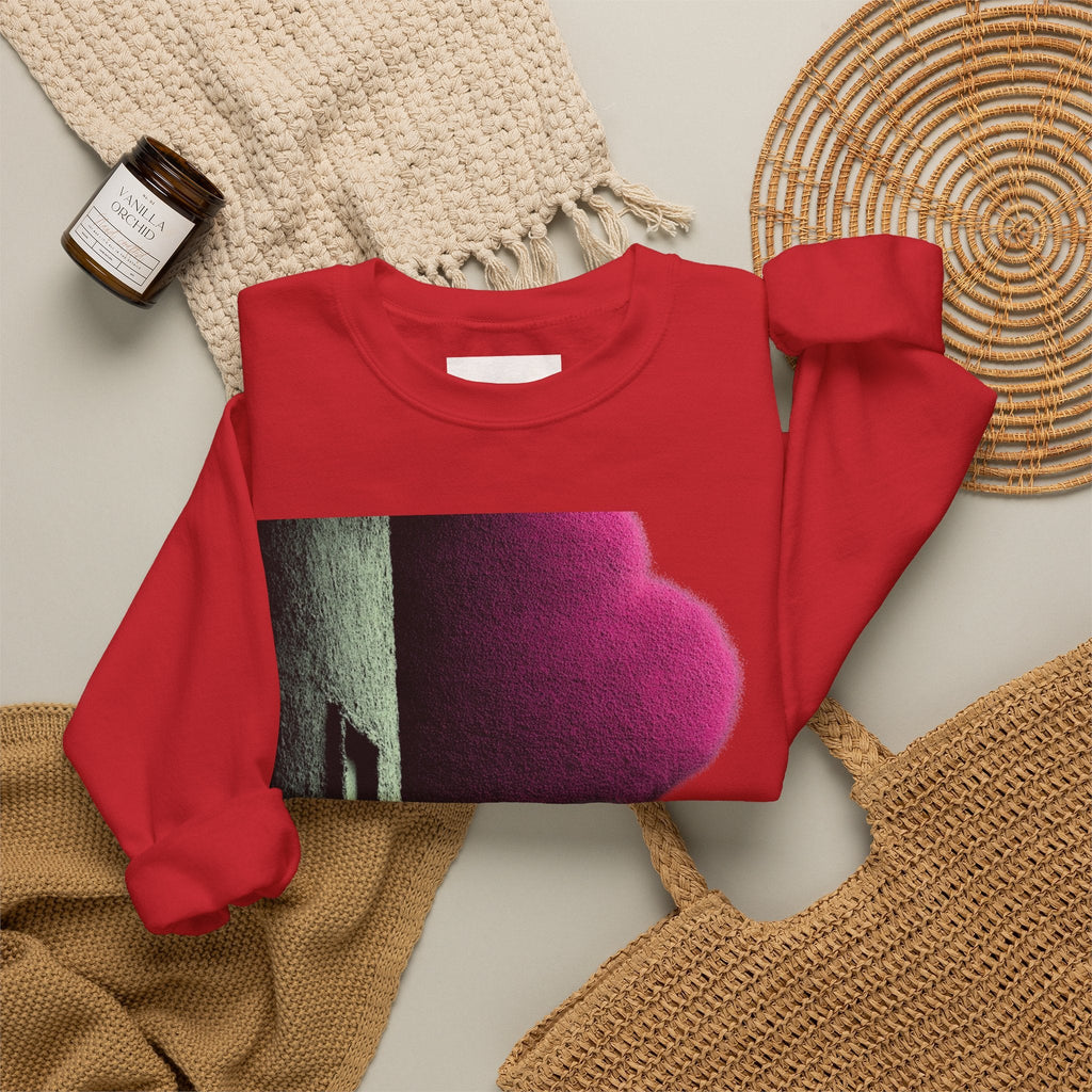 PURETE red crewneck sweatshirt with a bold abstract graphic print, laid flat on a neutral background with accessories.