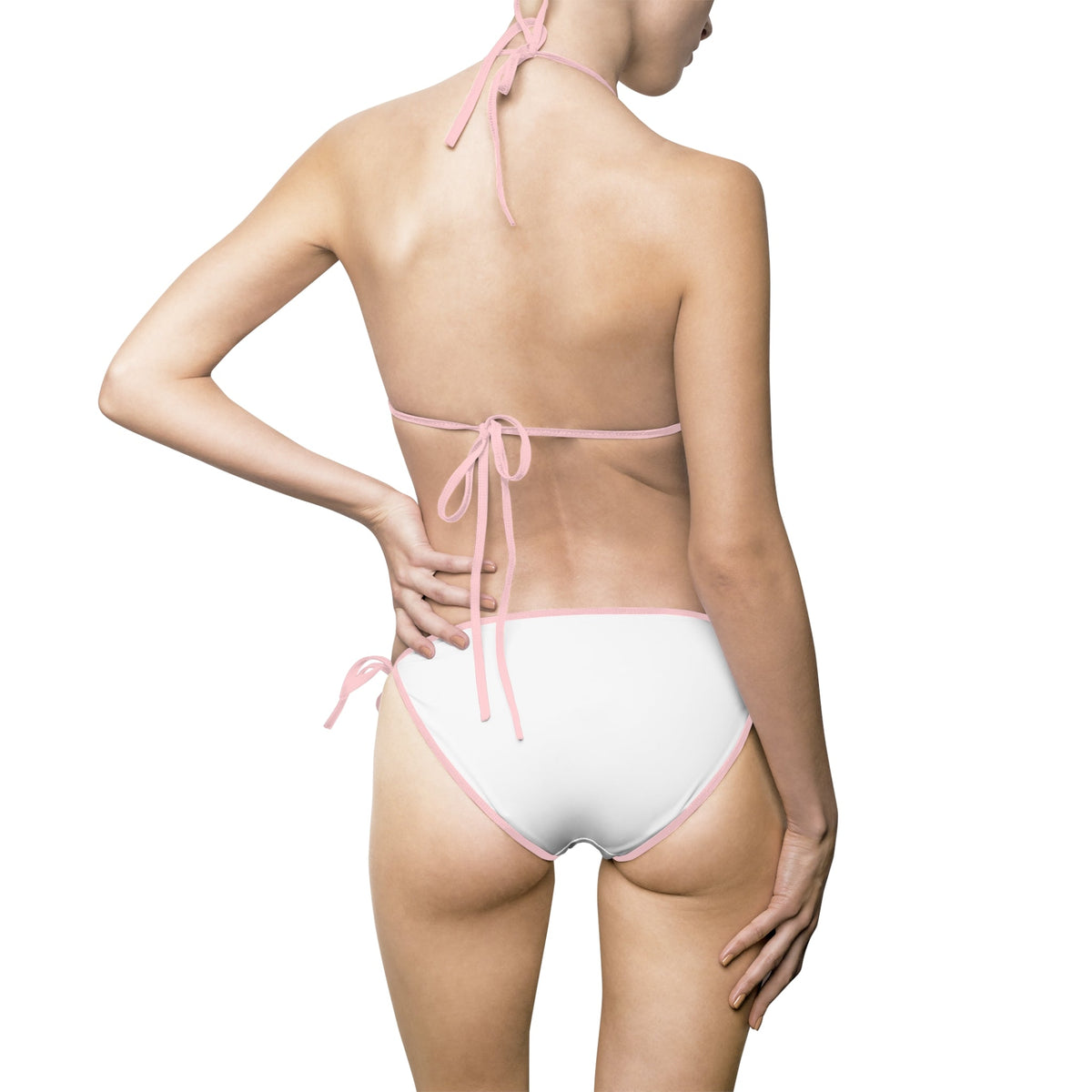 Back view of a model wearing a PURETE white bikini with soft pink trim and tie-side bottoms.