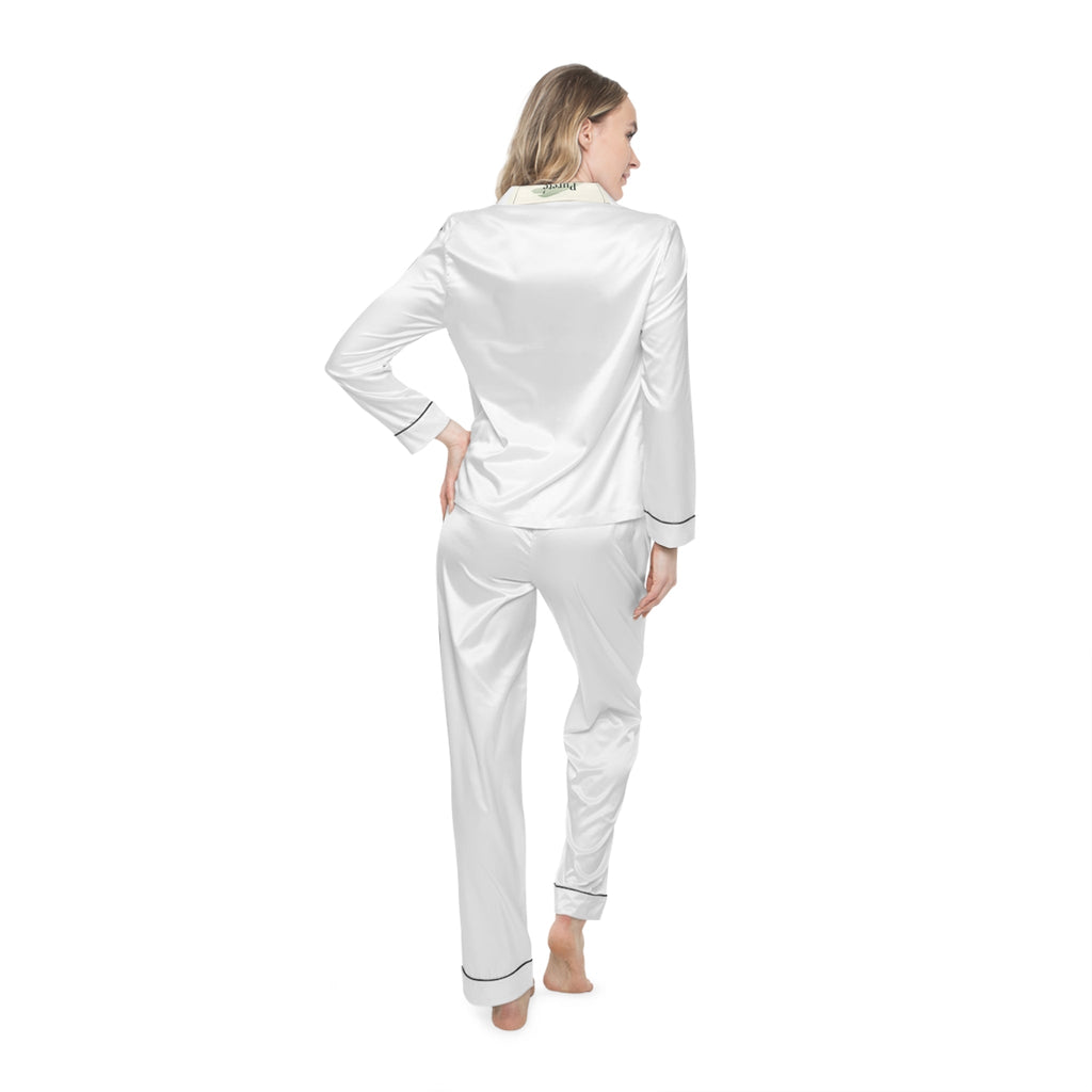 Woman wearing PURETE white satin pajama set with black trim, notch lapel, and drawstring waist, back view