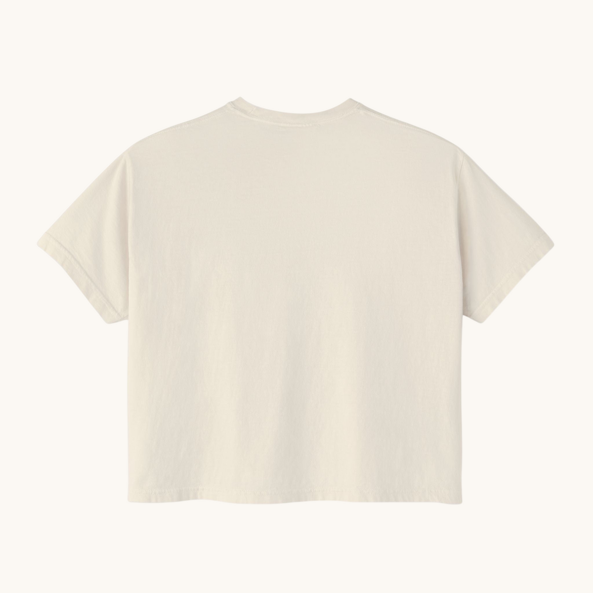 Back view of a PURETE women's oversized boxy t-shirt in a neutral cream pigment-dyed cotton fabric.