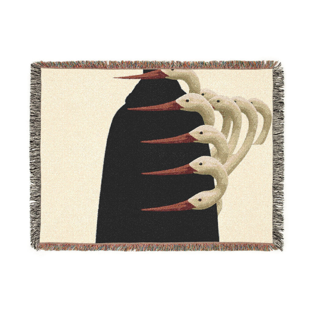PURETE woven cotton throw blanket featuring a surreal graphic of white birds on a black silhouette with fringe edges.