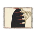PURETE woven cotton throw blanket featuring a surreal graphic of white bird heads on a black background with fringe