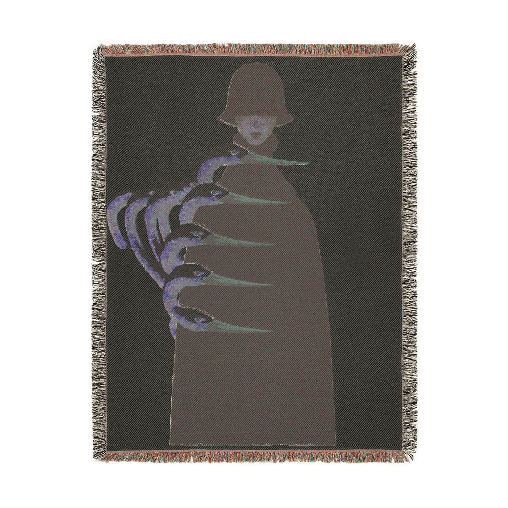 PURETE woven cotton throw blanket featuring a dark silhouette with abstract blue and green claw-like graphic elements.