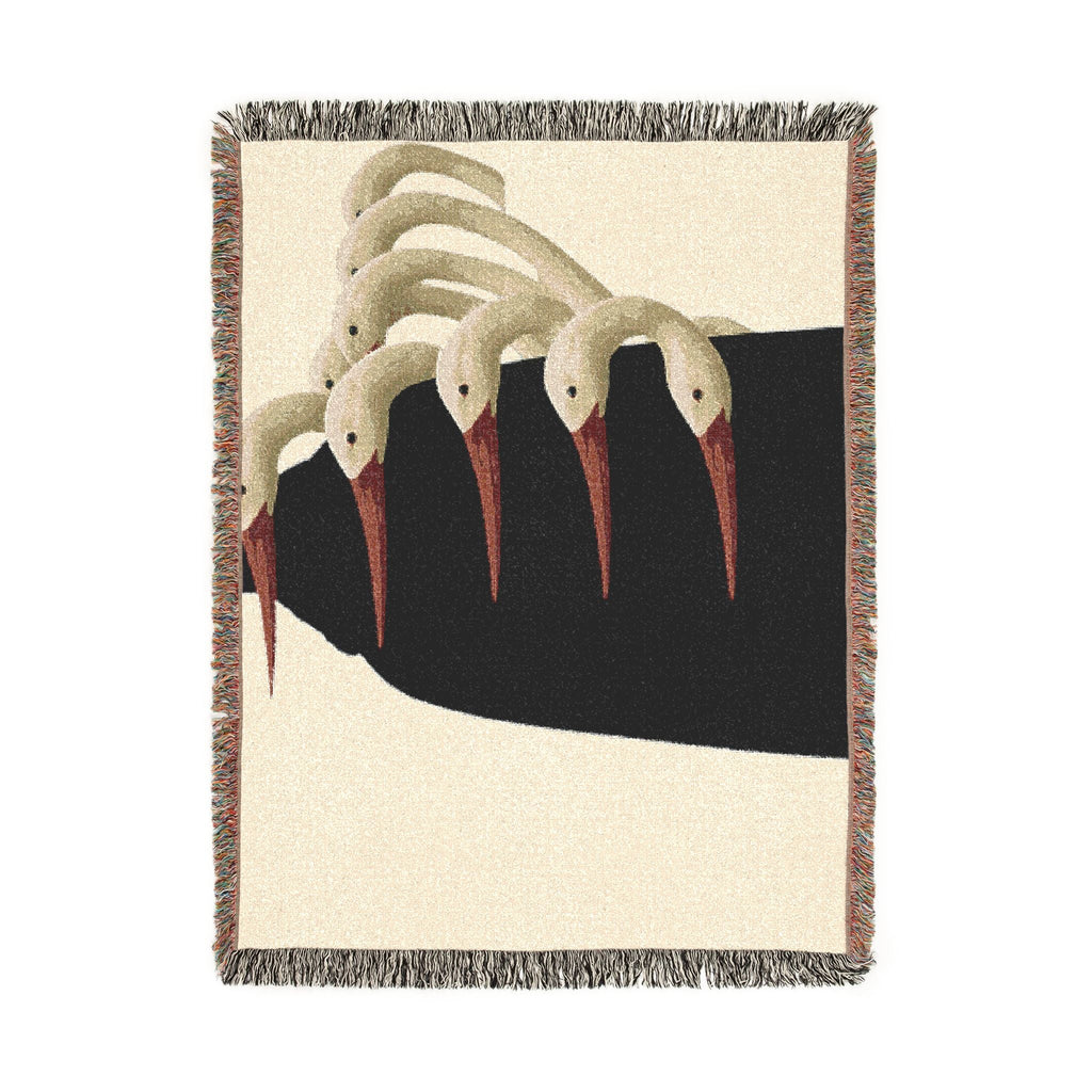 PURETE woven cotton throw blanket featuring a surrealist illustration of white birds with red beaks and colorful fringe