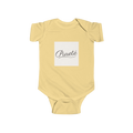 PURETE soft yellow infant bodysuit with a white square chest patch featuring elegant black French script text